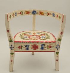 an image of a chair made out of wood with flowers on the back and sides