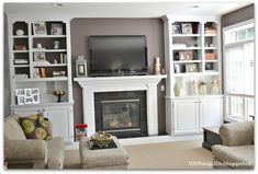 a living room filled with furniture and a flat screen tv mounted on a wall above a fire place