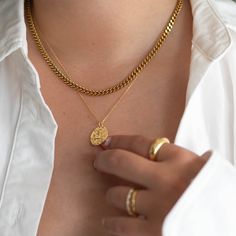 Our Curb Chain necklace adds style and edge to your outfit. This chain can be worn on its own as a statement or be layered with other chains from our shop. Great for people with sensitive skin and an affordable alternative to solid 18k gold because this necklace is waterproof and tarnish resistant. Hypoallergenic Stainless Steel with thick layer of 18k gold PVD coating. - 18k gold plated- Chain width: 4.3mm - Chain length: 18 inch + 2 inch extension- Water resistant, Tarnish resistant, Hypoaller Minimalist Figaro Chain Necklace With Pendant, Tarnish Resistant Link Chain Necklace For Layering, Tarnish Resistant Link Necklaces For Layering, Minimalist Tarnish Resistant Chain Link Necklace, Tarnish Resistant Recycled Gold Chain Necklace, Classic Gold Plated Curb Chain Necklace, Timeless Gold Curb Chain Necklace, Tarnish-resistant Link Chain Necklace For Layering, Minimalist Tarnish-resistant Chain Link Necklace