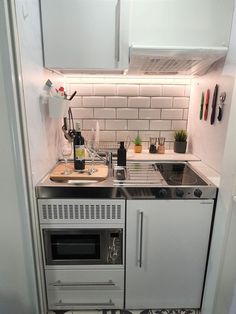 a kitchen with a stove and sink in it