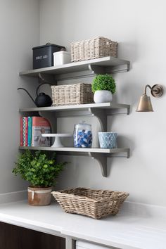 a shelf with baskets and books on it