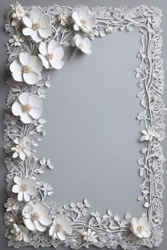 an ornate white frame with flowers and leaves on the edges, in front of a gray background