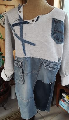 an old pair of jeans has been altered to look like a shirt with scissors on it