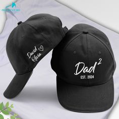 ❤️ Show off his proud title with this retro-style "Dad of 2" embroidered cap. Customized with kids' names and an "EST" date, this hat makes a thoughtful Father's Day or birthday gift that celebrates his love for his family. Surprise dad or grandpa with this custom cap that honors their special role. It's a stylish keepsake that will make them smile every time they wear it, whether at family outings or daily errands. ❤️ P R O D U C T * I N F O Introducing the Embroidery Cap - the perfect accessory for showcasing your style, ensuring comfort, and expressing your personal flair. Take your headwear to the next level with this trendy cap that effortlessly catches attention everywhere you venture. * 100% Polyester woven fabric: durability , lightweight and breathable feel * 6-panel, structured c Affordable Adjustable Snapback Hat For Father's Day, Personalized Baseball Cap For Father's Day, Father's Day Dad Hat With Letter Print, Black Adjustable Hat, Customizable Flat Bill Baseball Cap For Father's Day, Father's Day Hats With Letter Print, Father's Day Letter Print Baseball Cap, Father's Day Curved Bill Dad Hat With Letter Print, Customizable Black Baseball Cap For Father's Day