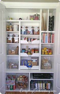 an organized pantry with white shelving and lots of food in baskets on the shelves