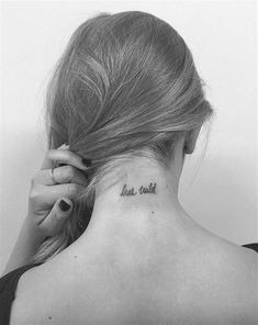 the back of a woman's neck has a small tattoo that reads, true truth