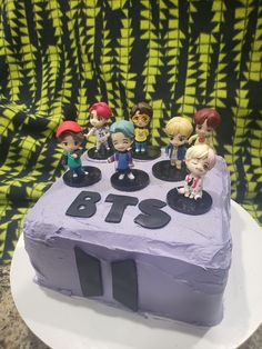 a birthday cake with figurines on top of it