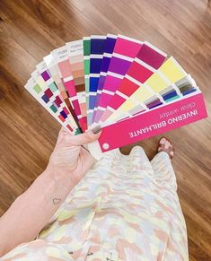 a person holding up some color samples in their hand