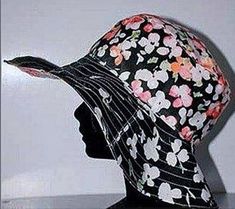 a woman's head wearing a hat with flowers on it