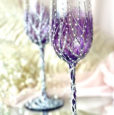 two wine glasses sitting next to each other on a table