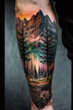 a man's leg with a mountain scene on it and trees in the foreground