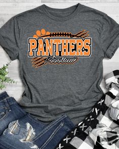 an orange and black shirt with the word panthers on it next to ripped jeans