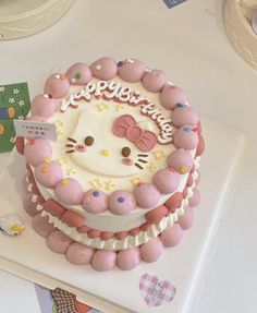 a hello kitty birthday cake on a table