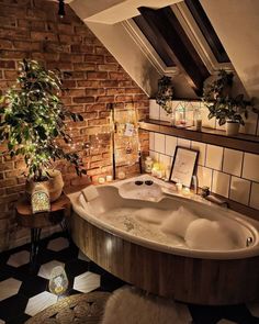 a bathroom with a large jacuzzi tub next to a potted plant