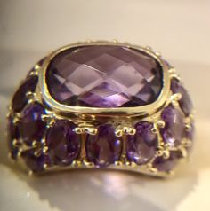 14K SOLID YELLOW GOLD Spectacular Natural Amethyst Dome Ring 5.76 cts Sz 7. Solid Yellow gold, marked 14K Natural Amethyst Ring Size: 7 Width: 5/8" Center Amethyst: 10.5 x 9mm, 4.0 cts, cushion cut Side stones: 1.76cts of 44 Round Amethyst Weight: 7.3 grams Dome Ring, Domed Ring, Amethyst Ring, Ring Size 7, Solid Yellow, Cushion Cut, Jewelry Watches, Jewelry Rings, Amethyst