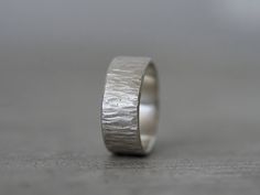 This is a hammer-textured fine silver/ sterling silver ring, made from recycled  metal, melted and rolled out inn my studio. The slightly higher content of fine silver allowed me to join the band by fusing instead of soldering. The ring was textured by hammering, resulting in a to a bark-like surface. This is an unfussy, simple, organic design, a perfect ring for everyday wear. Measurements: Size: 6.75; Width 7.8mm; The ring is 1.2mm thick. Material: Fine Silver and Sterling Silver Packaging: Yo Bark Ring, Partner Rings, Ring Selfie, Ring Of Honor, Ring Elegant, Ring Shots, Simple Organic, Organic Design, Elegant Ring