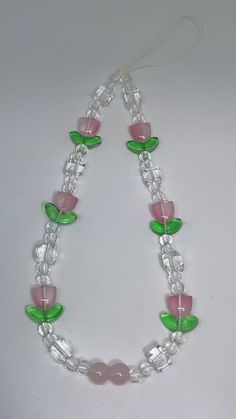 a necklace with pink, green and clear beads