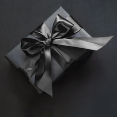 a black box with a silver bow on it