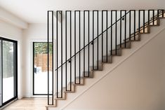 an empty room with stairs and sliding glass doors