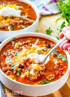 two white bowls filled with beef and mexican soup