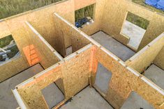 the inside of a house being built with plywood and wood framing on the floor