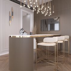 a modern kitchen with bar stools and gold accents