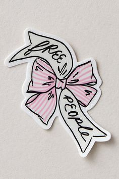 a pink and white sticker with a bow on it's side that says peace