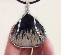 "Unique Wire Wrapped Palm Root Pendant, Fossil Pendant in Sterling Silver, Large Stone Pendant, Gift For Geologist.  The pattern of \"dancing flames\" on this beautiful palm wood turned stone, through nature's processes, is just outstanding!  It is truly amazing this is all natural and not hand painted. This one is a rare find indeed!  You may see a different picture than I do which is the magic of this Stone. The darker color on this Palm Wood, sometimes looks very far brown and sometimes black Unique Nickel-free Agate Jewelry, Unique Metal Jewelry With Large Stone, Collectible Silver Wire Wrapped Jewelry, Soldered Agate Jewelry As A Gift, Artisan Agate Jewelry Engraved, Soldered Agate Jewelry For Gift, Artisan Engraved Agate Jewelry, Unique Engraved Agate Jewelry, Adjustable Agate Jewelry With Large Pendant