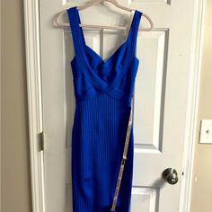 a blue dress hanging on a door with a chain attached to the front of it