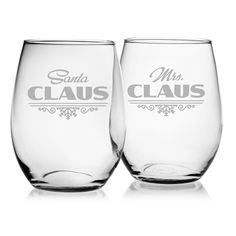 two wine glasses sitting next to each other on a white surface with the words, mr and mrs claus