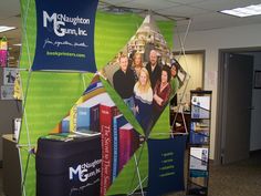 an office cubicle with a large poster on it's wall and various bookshelves