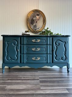 a blue painted dresser with gold trim