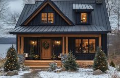 a house with christmas trees and lights on the front porch