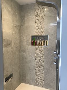 a shower with stone walls and shelves in it