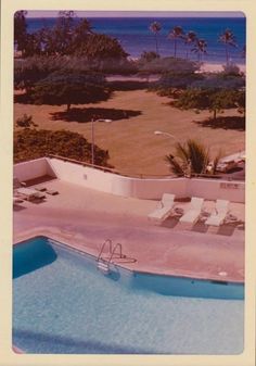 an empty swimming pool next to the beach