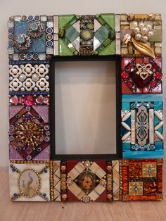 a multicolored photo frame with many different designs on it