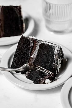 a slice of chocolate cake on a plate with a fork