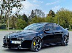 a black sports car parked in a parking lot