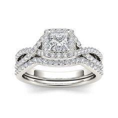 an engagement ring set with a princess cut diamond and two rows of diamonds on each band