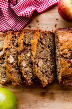 sliced loaf of banana nut bread next to an apple