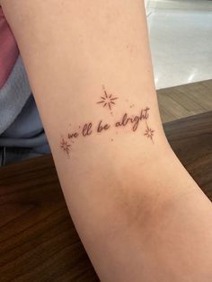 a tattoo saying we'll be alright with stars on the side of her arm