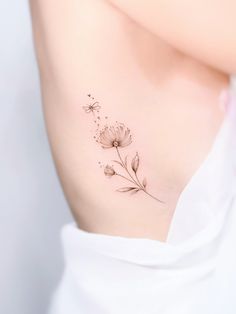 the back of a woman's neck with flowers on it