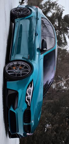 a blue sports car parked on the side of a building