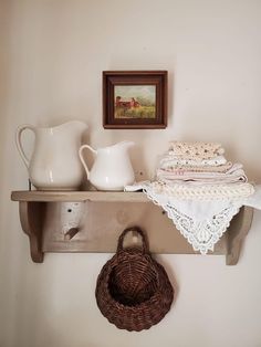 a shelf with some items on it and a basket hanging from the wall next to it