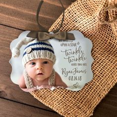 a baby's first christmas ornament with a photo on it