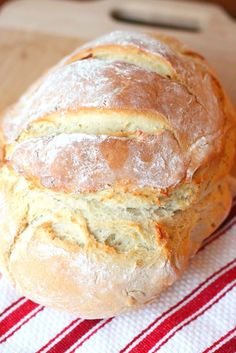 a loaf of bread sitting on top of a red and white towel