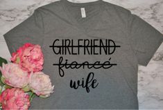 HEAD OVER TO WWW.VICTORIASMONOGRAMS.COM FOR CHEAPER PRICES Every new wife needs a comfy outfit  for the honeymoon, what is better than this adorable tshirt! Perfect for any new bride! Bella Canvas tee - Grey or white  S, M, L, XL, 2XL Lady Design, New Wife, Newly Married, Bella Canvas Tees, Cute Tshirts, Casual Tee, Comfy Outfits, Clothing Items, V Neck T Shirt