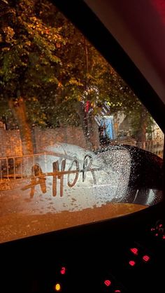 the windshield of a car with graffiti on it