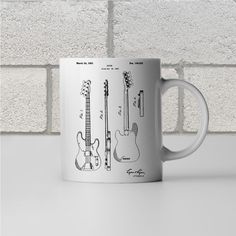 a white coffee mug with an electric guitar diagram on it's front and side