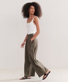 Relaxed Trouser Dark Moss Made from 100% textural raw silk for an effortless look that's equally polished and comfortable. With tailored pleats that seamlessly transition into a wide-leg silhouette, the Relaxed Trouser is the definition of California cool. Pair it with a classic cami or tee or embrace an oversized aesthetic from head-to-toe with your favorite lightweight knit. Tailored Wide Leg Summer Pants, Elegant Wide Leg Pants With Straight Hem For Daywear, Elegant Wide Leg Pants With Straight Hem, Effortless Wide Leg Summer Work Pants, Effortless Summer Wide Leg Work Pants, Effortless Wide Leg Pants For Summer Workwear, Classic Wide Leg Pants With Straight Hem For Summer, Loosely Fitted Classic Wide Leg Pants For Summer, Elegant Linen Wide Leg Pants For Daywear